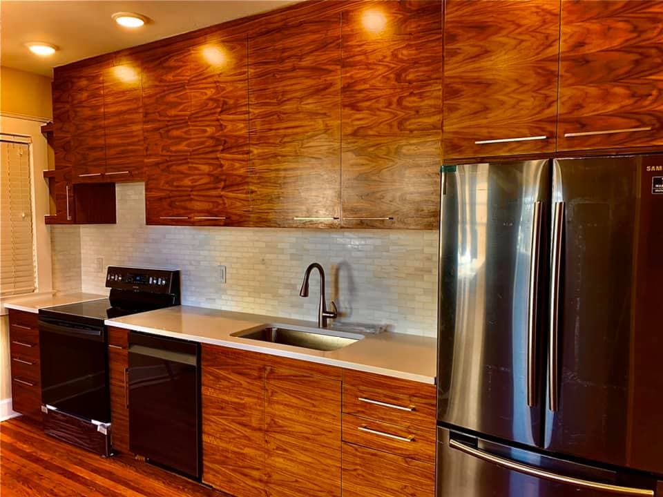 Custom wood cabinetry run with continuous grain across the doors