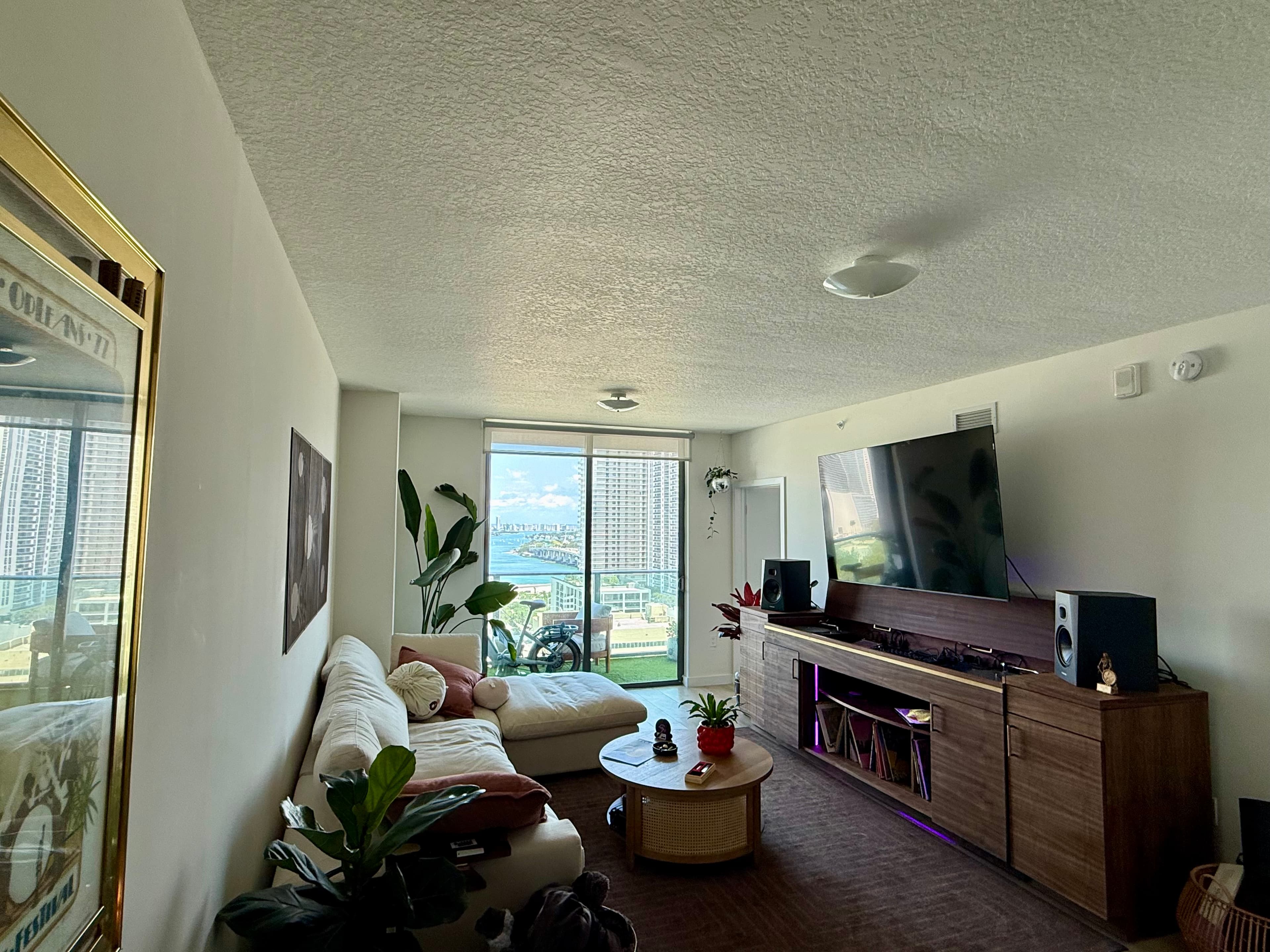 Water-view living room with built-in media casework and listening seating
