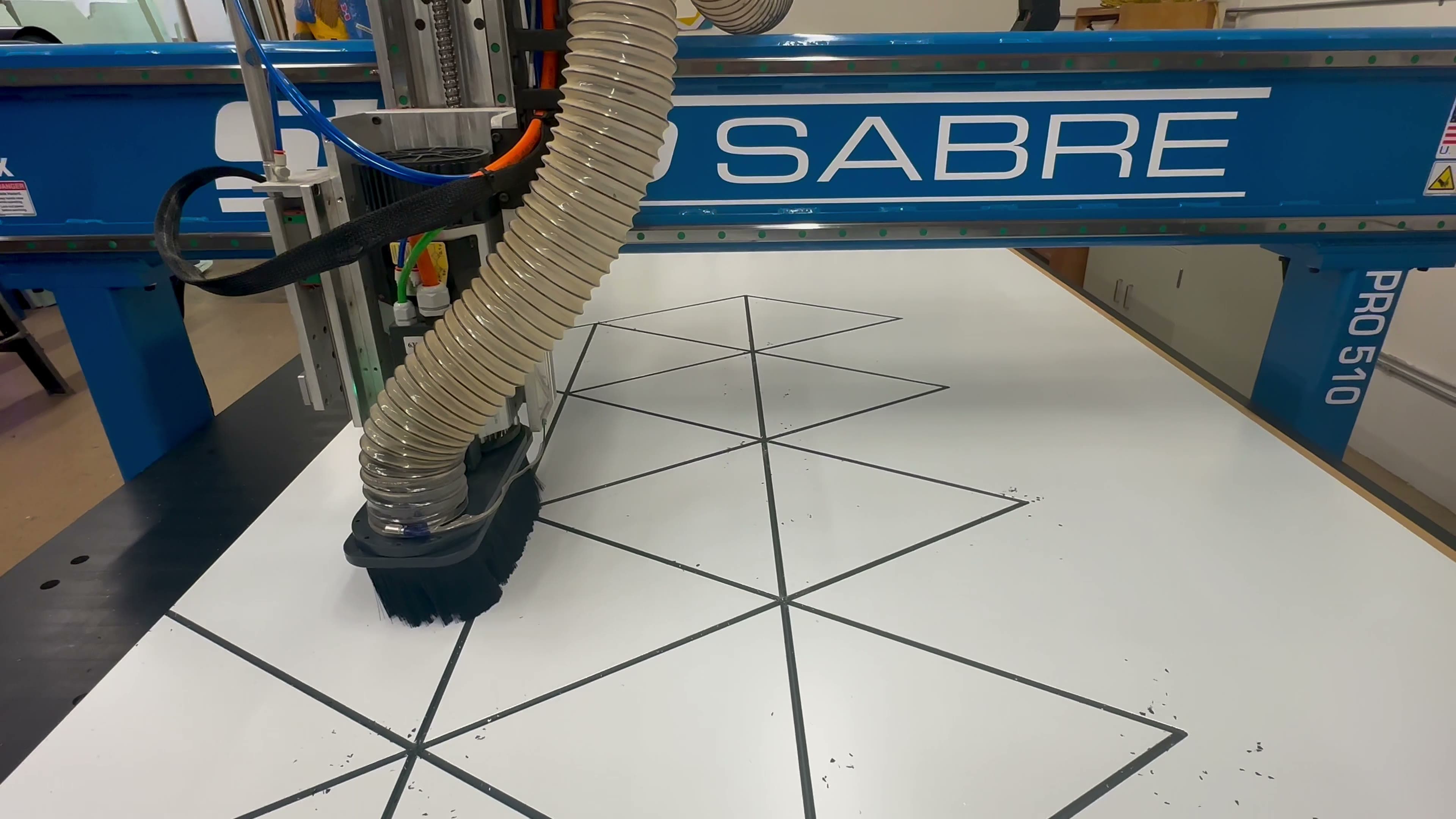 Fine etching pass across a white solid-surface panel
