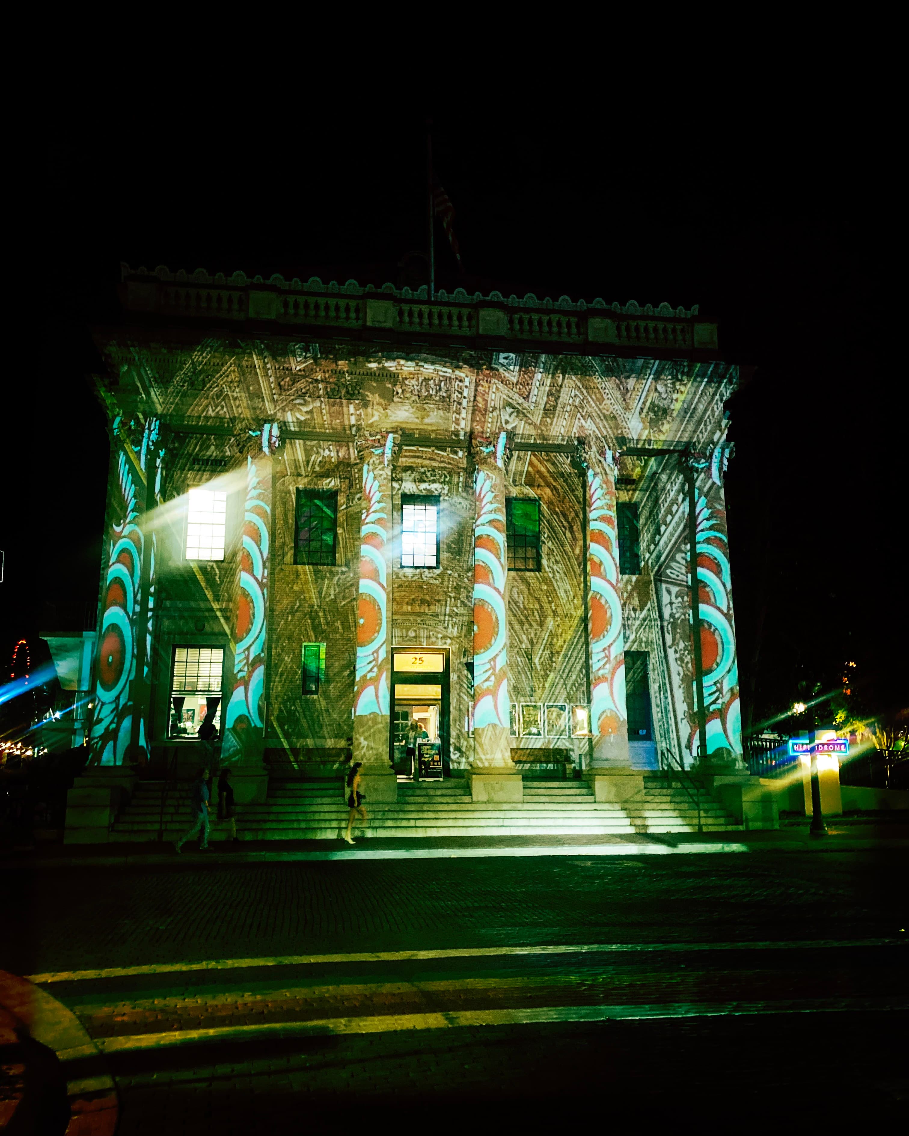 Projection-mapped building facade at night, Eclectic Electric creative production